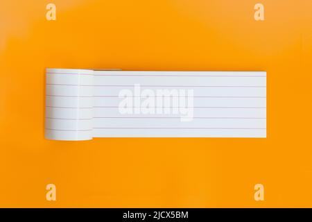 Long empty notebook for text on orange background. Open planner sheet, reminder. Copy space Stock Photo