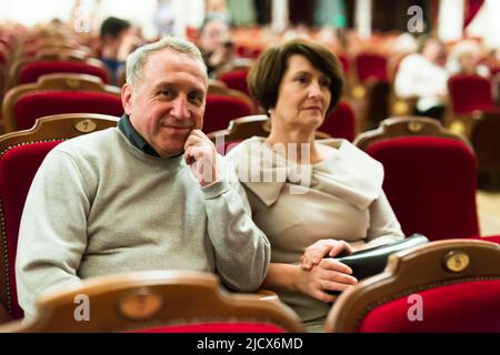 elderly couple watching play in the theater Stock Photo