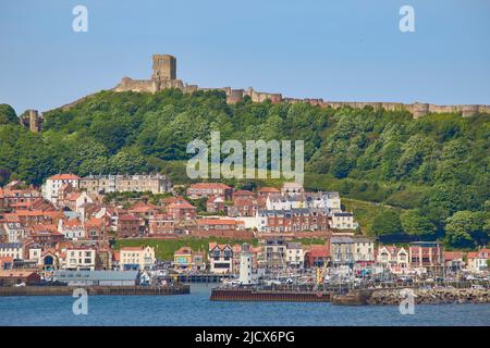 View of South Bay looking towards harbour and Scarborough Castle, Scarborough, Yorkshire, England, United Kingdom, Europe Stock Photo