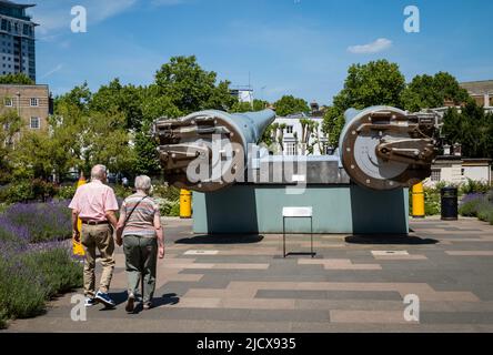 An elderly couple walk hand-in-hand at the front of the Imperial War Museum (IWM) in London. Stock Photo