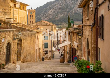 View of church clock tower and street in the old town of Pollenca, Pollenca, Majorca, Balearic Islands, Spain, Mediterranean, Europe Stock Photo