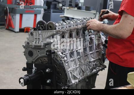 Mechanic working on diesel engine in the engine repair wokrshop Stock Photo