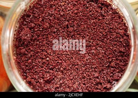 Sumac spice in the jar close up view Stock Photo