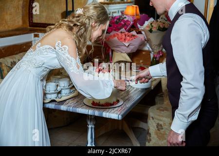The bride and groom cut the cake  Stock Photo