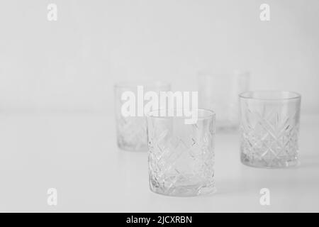 empty glasses with faceted geometrical pattern on grey background Stock Photo