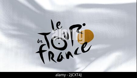 Paris, France, June 2022: Flag with the Tour de France logo waving. The Tour de France is the most important cycling event of the year and one of the Stock Photo
