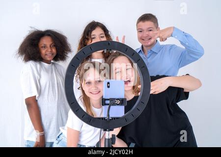 A group of teenagers shoot a video on Tiktok, a phone on a tripod. Selfie. Turkey, Istanbul, May 29, 2022. Stock Photo