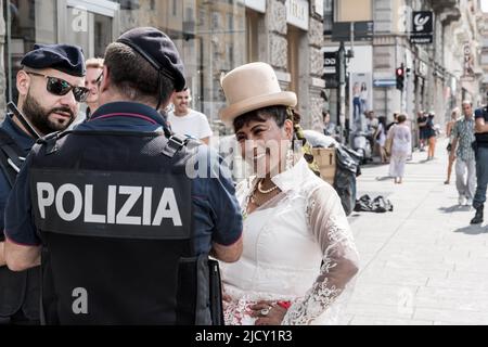 A woman speaks with police officers during the Bolivian celebrations of the Virgin of Urkupiña festival in the streets of Milano, Italy, Europe Stock Photo