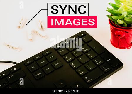 Conceptual caption Sync Images. Conceptual photo Making photos identical in all devices Accessible anywhere Computer Keyboard And Symbol.Information Stock Photo