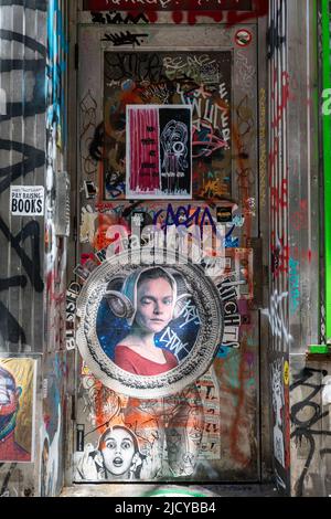 Layers of wheatpaste posters, tags and stickers on an exterior door in Lower East Side of Manhattan, New York City, United States of America Stock Photo