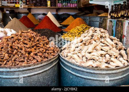 Fez, Morocco - June 16, 2022 Vegetables sold at the market in the medina of Fez during the coronavirus outbreak hitting Morocco, wearing a mask is man Stock Photo