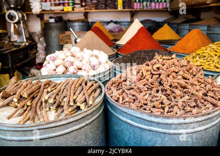 Fez, Morocco - June 16, 2022 Vegetables sold at the market in the medina of Fez during the coronavirus outbreak hitting Morocco, wearing a mask is man Stock Photo