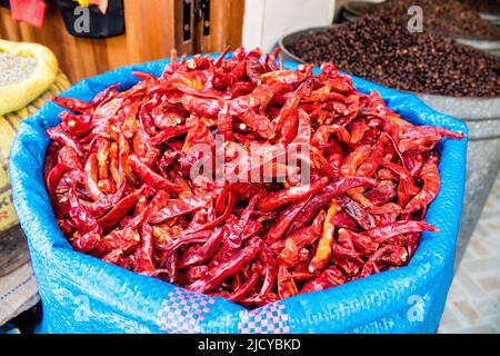 Fez, Morocco - June 16, 2022 Vegetables sold at the market in the medina of Fez during the coronavirus outbreak hitting Morocco, wearing a mask is man Stock Photo