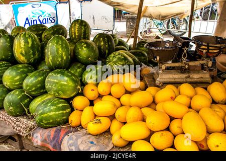 Fez, Morocco - June 16, 2022 Vegetables sold at the market in the medina of Fez during the coronavirus outbreak hitting Morocco, wearing a mask is man Stock Photo