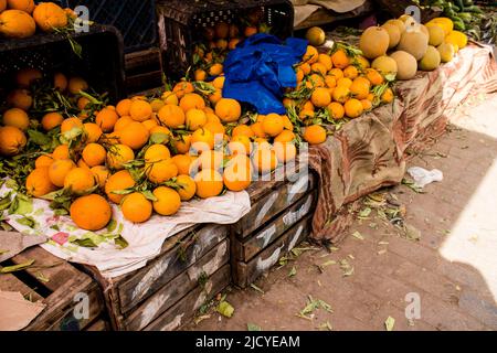 Fez, Morocco - June 16, 2022 Vegetables sold at the market in the medina of Fez during the coronavirus outbreak hitting Morocco, wearing a mask is man Stock Photo