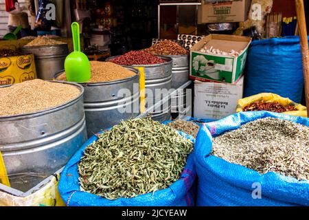 Fez, Morocco - June 16, 2022 Vegetables sold at the market in the medina of Fez during the coronavirus outbreak hitting Morocco, wearing a mask is man Stock Photo