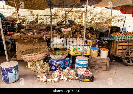 Fez, Morocco - June 16, 2022 Vegetables sold at the market in the medina of Fez during the coronavirus outbreak hitting Morocco, wearing a mask is man Stock Photo