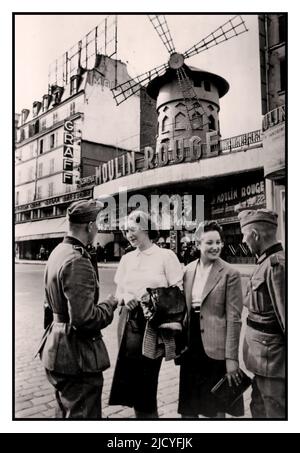 Occupied Paris France Nazi WW2 Propaganda image with two German Wehrmacht soldiers with two Parisian women in front of the Moulin Rouge, during the Nazi occupation of Paris June 1940 Paris France Stock Photo