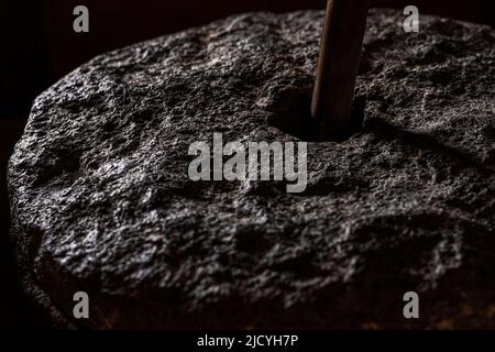Detail of a millstone used for grinding corn at the Eco Museum showing artifacts and displays of the agricultural and rural lifestyle of the local peo Stock Photo