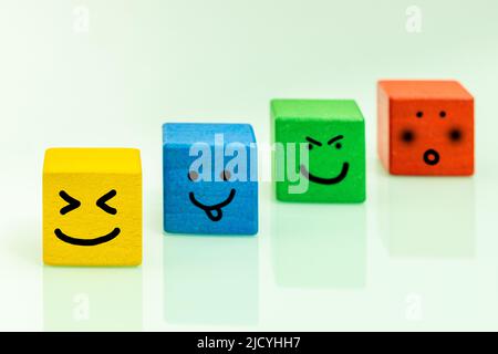 Colorful wooden blocks with emoticons Positive emotions, smiles, facial ...