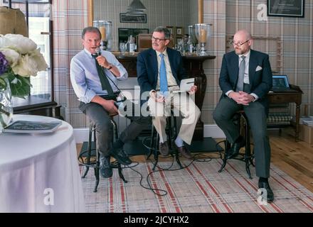 Group talk at Huntsman tailors at the Concours On Savile Row classic car show London UK Stock Photo