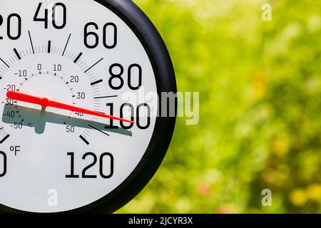 Outdoor thermometer in the sun during heatwave. Hot weather, high temperature and heat warning concept. Stock Photo