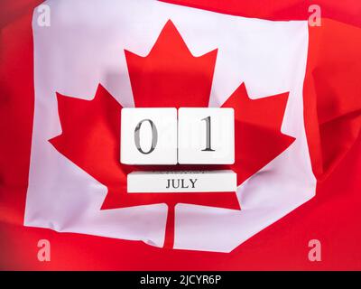 Canada Day, July 1 concept with Canadian flag on red Stock Photo