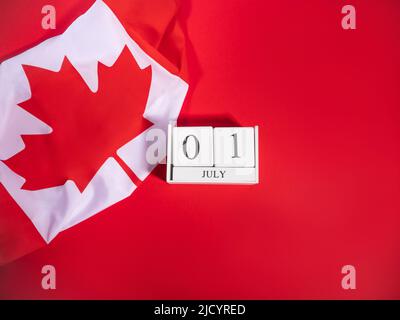 Canada Day, July 1 concept with Canadian flag on red Stock Photo