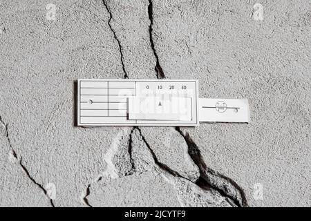 Monitoring a crack in a concrete wall in a house Stock Photo