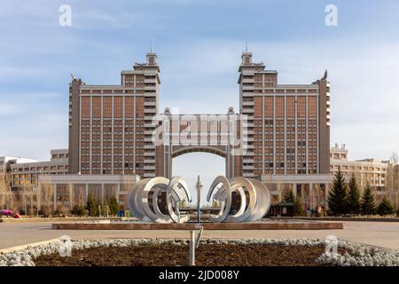 Landscape of Nur Sultan, Kazakhstan (Astana) with monumental Gate, Bayterek Tower and modern metal sculpture, symmetrical view. Stock Photo