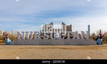 Nur Sultan city logo sign in Lovers Park with Nur Sultan (Astana) skyline in the background, Kazakhstan. Stock Photo