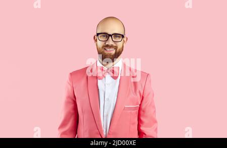 Portrait of smiling man in suit isolated on pink background Stock Photo