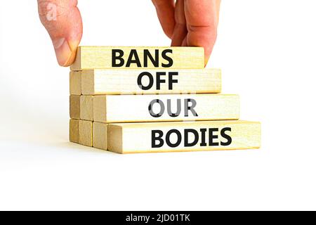 Bans off our bodies symbol. Concept words Bans off our bodies on wooden blocks on beautiful white table white background. Women rights concept. Busine Stock Photo