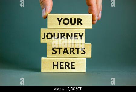 Your journey starts here symbol. Concept words Your journey starts here on wooden blocks on a beautiful grey table grey background. Business, motivati Stock Photo