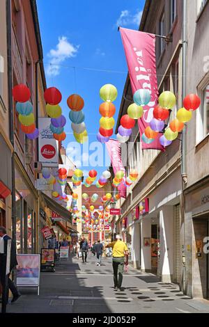 Würzburg, Germany - June 2022: Alley called 'Schustergasse'  decorated with colorful lanterns in old town Stock Photo