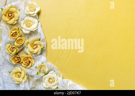 white lace and yellow paper roses background Stock Photo