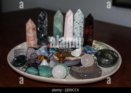 Crystals, tumbles and gemstones towers on wooden table. Minerals for Crystal Magic Ritual, Witchcraft, Relax, Harmony life balance. Spiritual practice Stock Photo