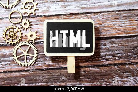 Concept image a wooden block and word - HTML - short for HyperText Markup Language - on white background. The cubes are located on the keyboard Stock Photo
