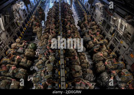 U.S. Army Paratroopers, Air Force joint terminal attack controller and Special Tactic Operators board a C-17 Globemaster III from the 176th Airlift Squadron at Joint Base Elmendorf-Richardson, Alaska, June 15, 2022 during RED FLAG-Alaska 22-2. Approximately 1,600 service members from three nations participate in flying, maintaining and supporting more than 70 aircraft from over 22 units during this iteration of exercise. The Paratroopers are assigned to the 2nd Infantry Brigade Combat Team (Airborne), 11th Airborne Division, JTACs are assigned to the 3rd Air Operation Squadron both at JBER and Stock Photo