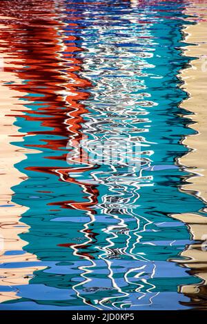 Patterns and colours in reflections of boats in harbour water Stock ...