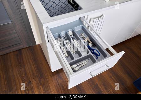 Photo of drawer with various kitchen utensils 