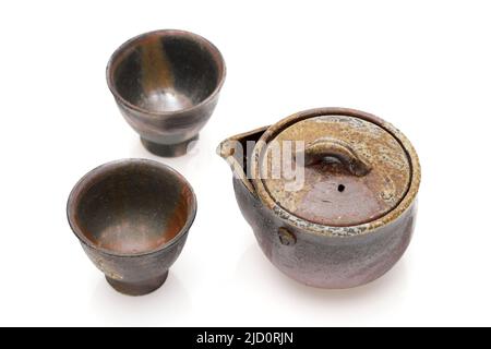 Japanese green tea in a tea set with cup and pot isolated on a white background Stock Photo