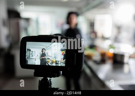 Close up of camera recording head cook presenting herbs and ingredients for dish while doing a cooking course. Culinary content creator preparing gourmet food for internet culinary vlog. Stock Photo