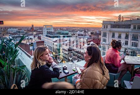 People relaxing on a rooftop overlooking the city Madrid, Spain Stock Photo