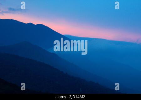 Early morning view of the slope of Mount Pangrango and lower adjacent hills in Mount Gede Pangrango National Park as seen from Cibulao, Tugu Utara, Cisarua, Bogor, Indonesia. Stock Photo