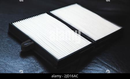 New car air filter on a leather black car seat Stock Photo