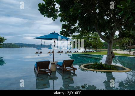 Aerial view of Naka Island near Phuket Thailand, a tropical Island in Thailand with beach chairs in the pool.  Stock Photo