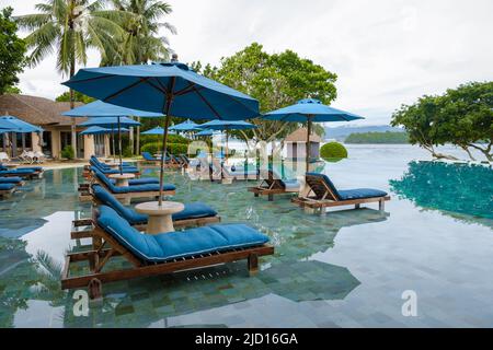 Aerial view of Naka Island near Phuket Thailand, a tropical Island in Thailand with beach chairs in the pool.  Stock Photo