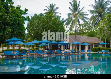 Aerial view of Naka Island near Phuket Thailand, a tropical Island in Thailand with beach chairs in the pool.  Stock Photo