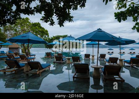 Aerial view of Naka Island near Phuket Thailand, a tropical Island in Thailand with beach chairs in the pool.  Stock Photo